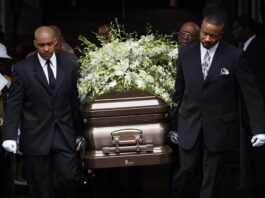 Members carrying a casket with the remains of their loved one