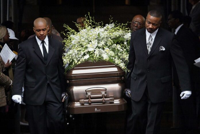 Members carrying a casket with the remains of their loved one