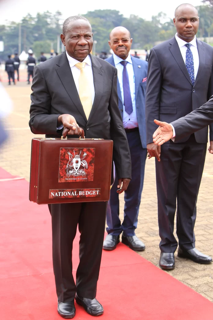 Hon. Matia Kasaija, the Finance Minister with Minister Henry Musasizi (Right), in-charge of General Duties and Minister Amos Lugoloobi