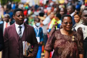 MP Betty Nambooze Bakireke together with the husband as they match to attend mass at Namugongo Catholic Martyrs Shrine 
