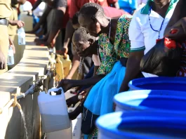 Pilgrims fetching the Holy water from the well at Namugongo Martyrs Catholic Shrine