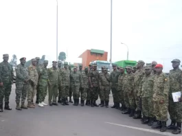 Brig. Gen Stephen Tumwesigye Kashure (in a UPDF ceremonial uniform) the Chief Evaluator of the Command Post Exercise and the Uganda contingent after arriving in Rwanda for the East African Community (EAC) 13th Armed Forces Command Post Exercise. Courtesy photo