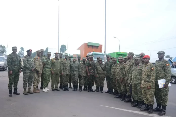 Brig. Gen Stephen Tumwesigye Kashure (in a UPDF ceremonial uniform) the Chief Evaluator of the Command Post Exercise and the Uganda contingent after arriving in Rwanda for the East African Community (EAC) 13th Armed Forces Command Post Exercise. Courtesy photo