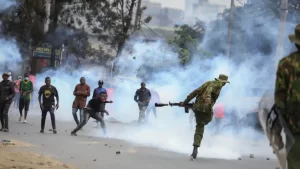 Protesters and Military police exchanging stones and canisters of tear gas