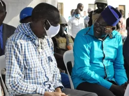 Dr. Kizza Besigye sitting with Eng. Patrick Amuriat Oboi